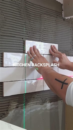 one tile at a time.Turning vision into reality — Backsplash installation underway.
