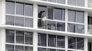 Daredevil window washer dances with death on high-rise apartment ledge