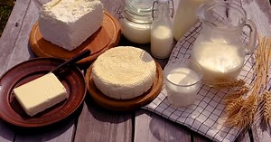 Fresh Milk Products on Wooden Table Close Up