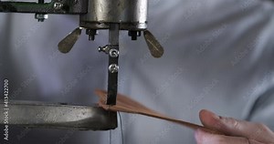 Detailed Plan of Antique Leather Stitching Machine. Sew. Sewing Art. Manual Drive. Man Spins Handle. Machine Makes Even Seam on Piece of Genuine Processed Leather. Custom Leather Accessory Making