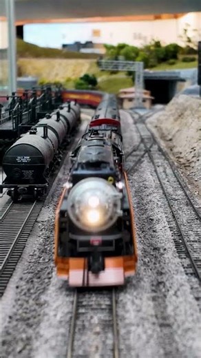 A super Daylight crosses under the bridges near Army Point on our HO layout