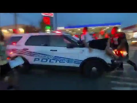 Protesters hit by police car as it drives through crowd in Detroit