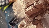 Slow motion close up handheld shot of a sledge hammer striking a...