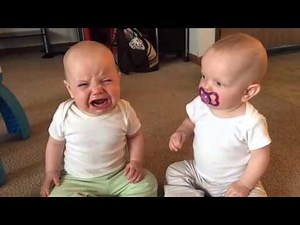 Twin baby girls fight over pacifier