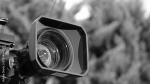 Professional broadcast camera in outdoor studio shooting video. Broadcasting industry. Black and White Footage