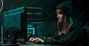 Nonconformist Teenage Hacker Girl Using Computer for Attacking Corporate Servers with malware.
