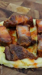 Delicious arepa with melted mozzarella cheese and pan fried chicharron carnudo or pork rinds.