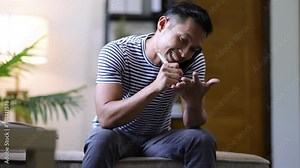 Man at home making phone call with his friend.