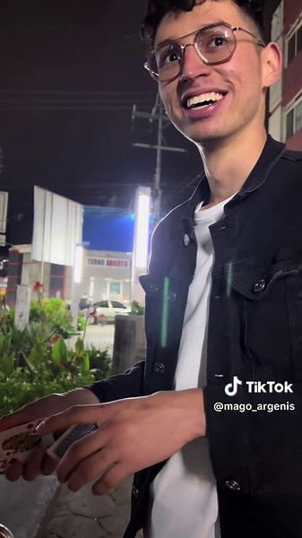Impressive Card Trick Performance on a Nighttime Street