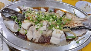 Steam patin fish with ginger and scallion on the plate