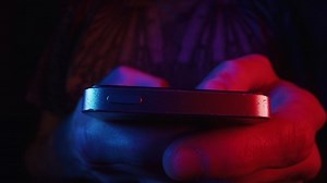 Close up macro shot of hand using touchscreen cell phone