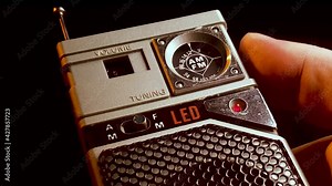 Vintage AM FM radio transistor device from 1970's, searching for stations, close up