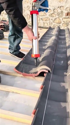 Installing modern corrugated roof tiles using adhesive tools for strong neat finishing