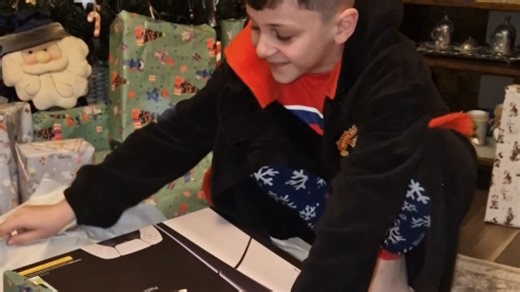 10-year-old boy receives a PS5 from his mom on Christmas