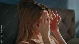 Awaking woman sitting bed opening eyes after sleep close up. Sleepy girl waking