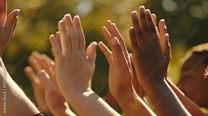 The sound of clapping hands and stomping feet creates a rhythmic wave of support and encouragement.