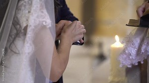 Priest put on wedding rings to bride and groom hands in church Stock Video