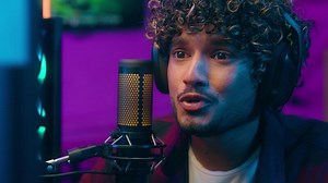 Indian Arabian Latino man talking microphone broadcasting blogger vlogger influence audience headphones excited emotional tell computer game player virtual communicate mic stream web cyberspace