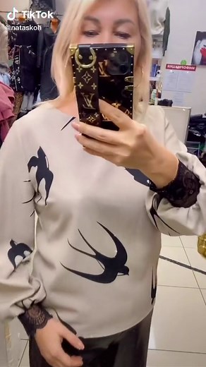 Trying On Trendy Sweaters at the Clothing Store