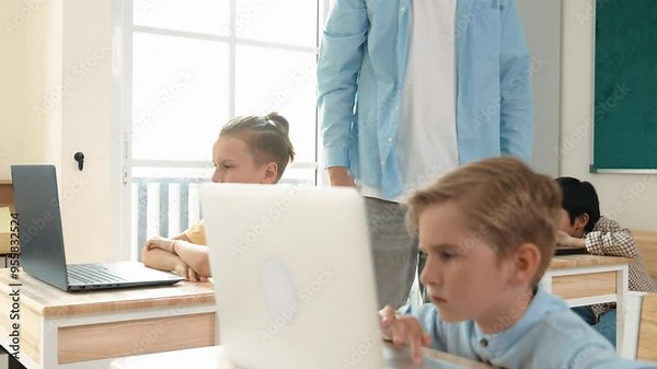 Caucasian teacher helping american student coding engineering prompt while diverse student using software generated AI. Smart attractive children sitting and programing system. Education. Pedagogy.