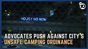 Homeless advocates light up I-5 overpass sign in response to encampment ban