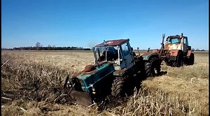 Rusty Tractors Plowing Fields in Rural Landscape