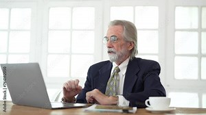 Senior businessman working on laptop computer. Senior retirement man enjoys chatting with someone using his laptop. Achievement career wealth business concept. Happy retire during labor concept.