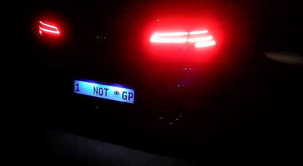 Close-Up of Car Taillights in Dim Light