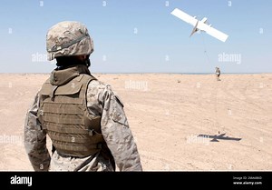 US Marine Corps (USMC) Lance Corporal (LCPL) David Fierro, 2nd Military Police (MP) Battalion (BN), Bravo Company (B CO), 5th Platoon (PLT), launches the Dragon Eye Unmanned Aerial Vehicle (UAV) along the MSR (main supply road) Lyman Road. The Dragon Eye is a small plane guided by computers and provides real time video of the terrain below it. The Marines use the Dragon Eye during their patrol to find any IED's (Improvised Explosive Device) or suspicious people traveling on the roads. Base: Camp