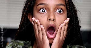 Excited child shocking reaction. girl reacts with surprise with open mouth
