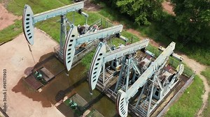 Working Pumpjack industrial oil pump jack working and pumping crude oil for fossil fuel energy at oil and gas a land rig onshore drilling rig