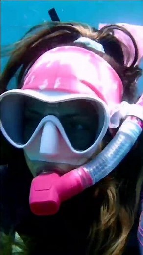 A close-up of a female snorkeling