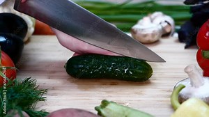 The cook cuts the cucumber in half, it is possible to insert the text