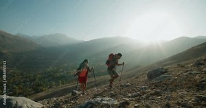 Hikers people hiking - healthy active lifestyle. Hiker people hiking in beautiful mountain nature landscape. Woman and man hikers walking during trekking hike.steadycam shot