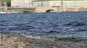SLOW MOTION: Waves of the Neva river on the Trinity Bridge background in the summer - St. Petersburg, Russia