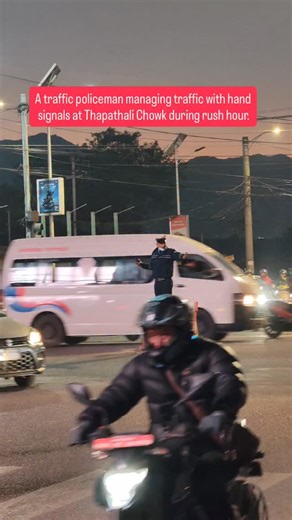 Trending Nepal Videos on Instagram: "A traffic policeman managing traffic with hand signals at Thapathali Chowk during rush hour."