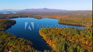 Mirror Lake shore at Lake Winnipesaukee aerial view with Ossipee Mountains at the background in fall in town of Wolfeboro, New Hampshire NH, USA.