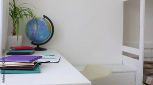 Girl learning lessons, cute girl making her homework, schoolgirl studing at home at the table, children's education, back to school