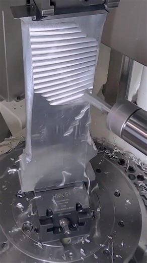Fast CNC Machining of a Turbine Blade This video is an example of 5-Axis CNC milling. CNC milling is a subtractive manufacturing process where a rotating cutting tool controlled by a computer numerical control (CNC) machine removes material from a workpiece to create a desired shape. This machining process is used to create a wide variety of parts and products in various industries including aerospace, automotive, and medical. CAM Software - hypermill #machinist #machineshop #mechanicalengineeri
