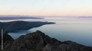 Aerial view of the Jagged Mountains, Lochs and Sea on the Isle of Skye, Scotland UK at Sunrise with Colourful Skies. Hiking and camping in the Cuillin Mountains.