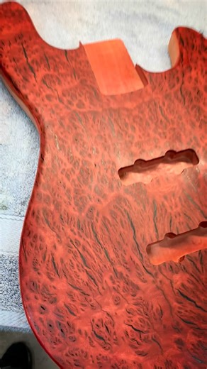 The Vecna guitar! Made from Vecna wood, a rare tree found only in the upside down. This is actually eucalyptus wood, not from the upside down but from the outback. It has a very unique Burl that looks very….strange. Technically it’s called Coolibah, and it got this unique grain due to infestation of worms. We sealed it with thin epoxy, filled the wormholes, stained it red, sprayed a black burst, cleared and buffed to a fine gloss. #strangerthings #eddiemunson #vecna | Gepettos Guild