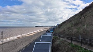 . View over beach huts, the promenade and the beach in the seaside town of Cromer on the North Norfolk coast Stock Video