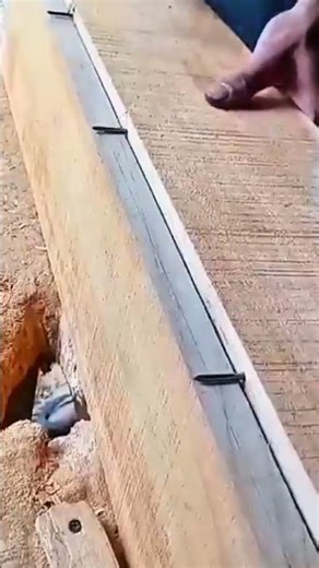 Drilling holes into thick wooden planks using power drill and marking precise measurements with ink