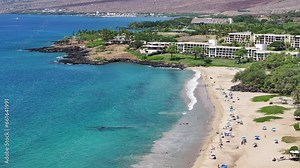 Aerial Kona Hawaii ocean coast beach resort landscape pull. Big Island. Luxury exclusive homes on coast with golf course. Volcanic lava flow environment. Economy tourism. Tropical beach recreation.