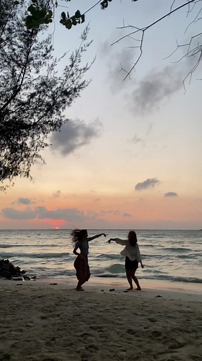 Beach Vibes: Girls Dancing at the Shore