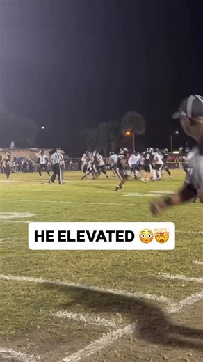 High School Football Player Leaps Over Defender