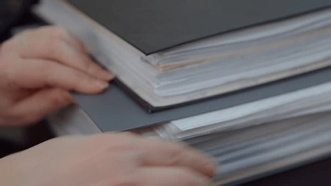 clip-4007602519-hands-adjusting-stack-office-documents