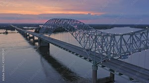 Aerial flying over traffic on the Hernando de Soto Bridge that crosses the Mississippi River at night. The bridge crosses into Arkansas. Memphis, Tennessee, USA