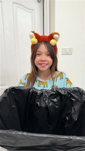 Kids learn to throw trash in a trash can