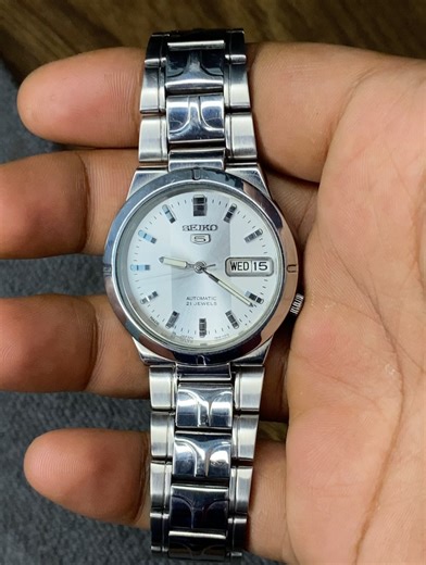Bengal Curator - বেঙ্গল কিউরেটর on Instagram: "Seiko 5 SNK037 White & Silver Sunburst Dial Transparent Back. Price - 5700 Bdt Watch Details Case Size - 36 mm Ref - 7S26-01Z0 A4 Serial - 553489 Jewel- 21 Made in Japan Stainless Steel Day/Date Dial Color - Silver 100% AUTHENTIC PRE-OWNED WATCH 6 MONTHS OF SERVICE WARRANTY Free delivery all over Bangladesh includes wooden box *pictures are also part of the description. #watches #vintagewatch #watchesbd #seiko5"